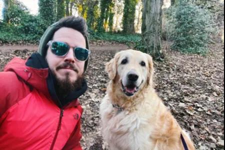 Photo of Michael McDonald outdoors with his dog