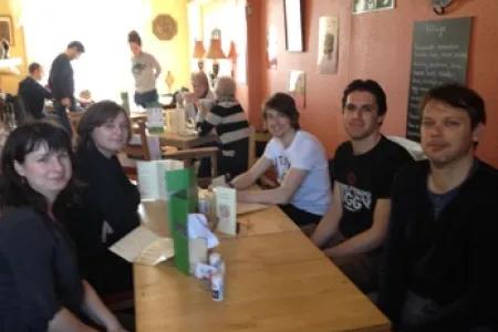 Photo of the lab group sitting around a table in a café whilst on a lab outing to St Andrews