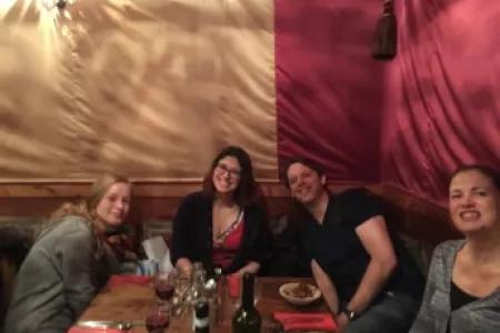 Photo of the ab group members sat around a table with drinks on it.