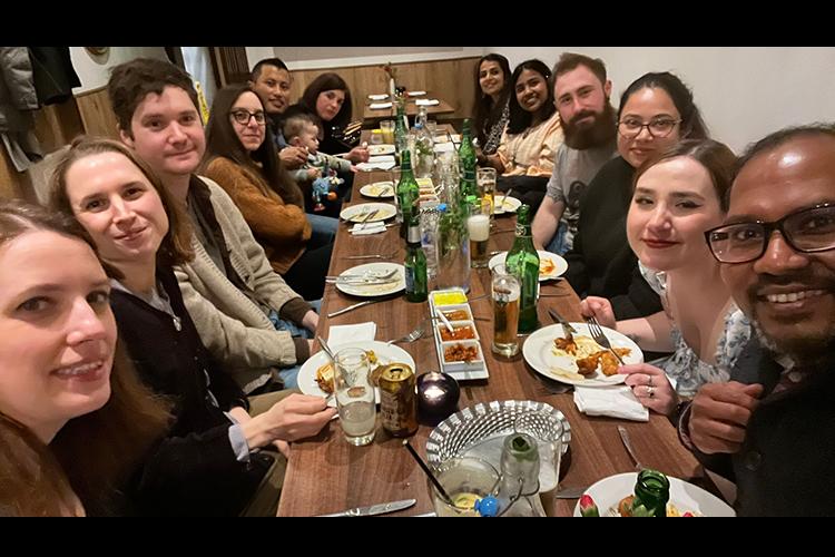 Group members gathered round a table to share a meal