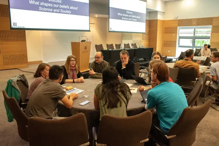 Image of delegates discussing around a table