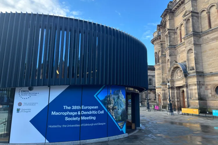 A building with a round building in the background