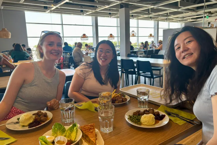 A group of people sitting at a table with food