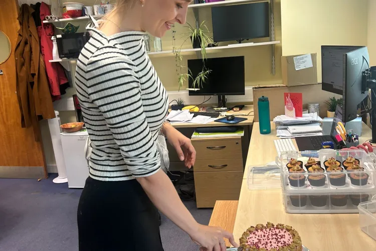 A person cutting a cake