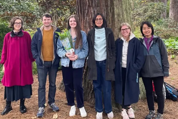 Six people stand infront a large tree at the Royal Botanic Garden Edinburgh
