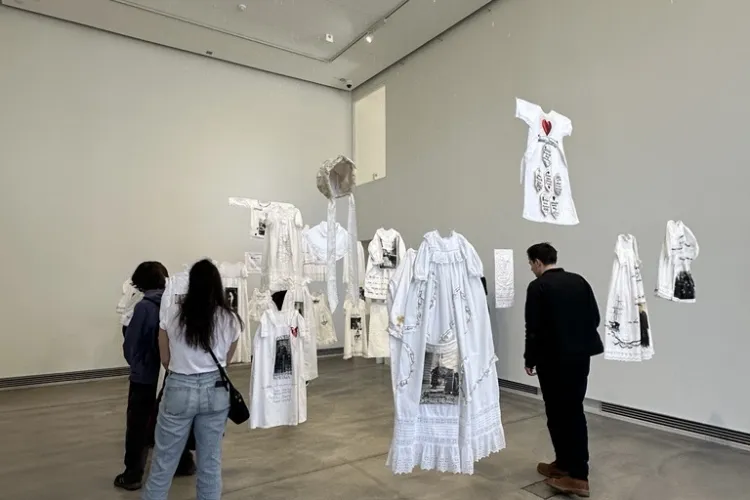 Students looking at exhibition piece