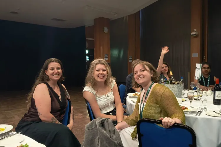 Taylor, Louise and Wulfrun smiling at the conference dinner