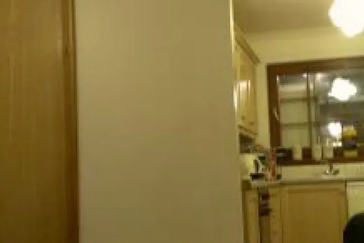 Panorama photo of the group sitting around a table indoors