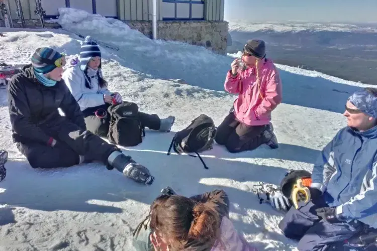 Photo of some group members sitting in the snow