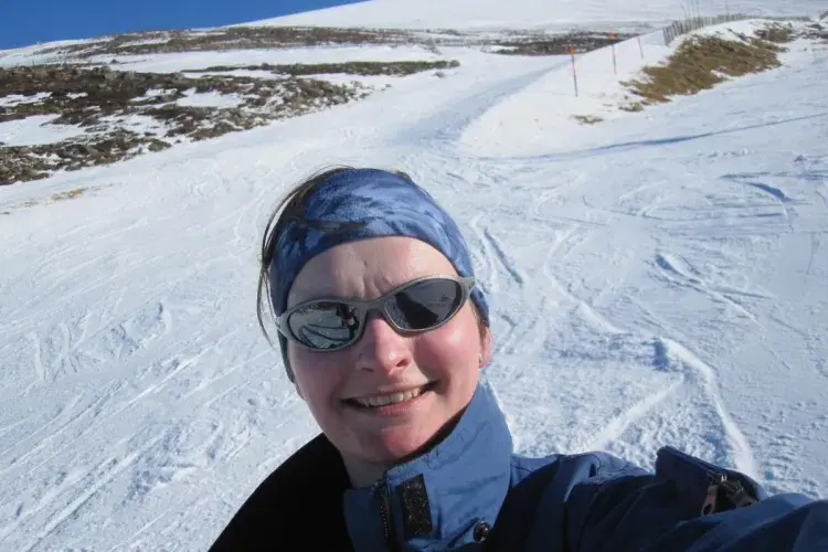 A selfie of Julie Blyth on the slope, in ski suit and sunglasses