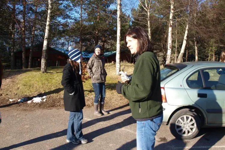 Lab members in the car park, with cars and trees nearby