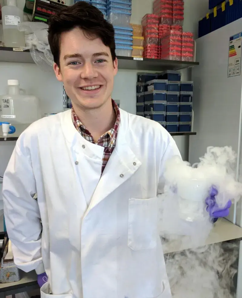 Brendan Largley in the lab, smiling.