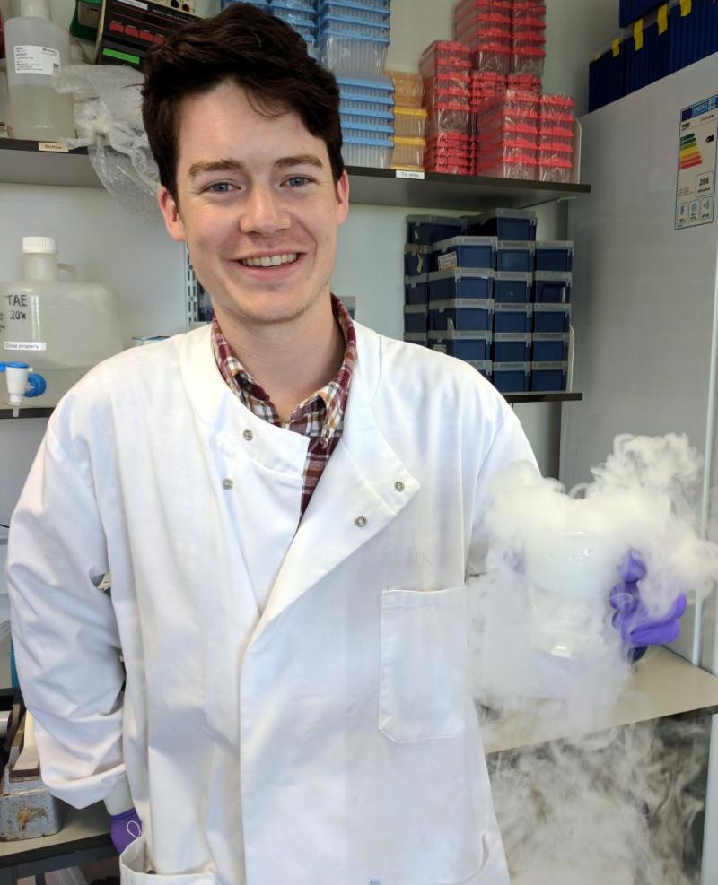 Brendan Largley in the lab, smiling.