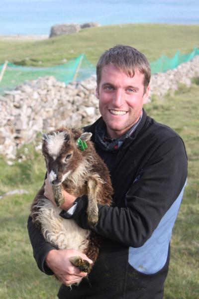 Dan Nussey holding a Soay lamb.