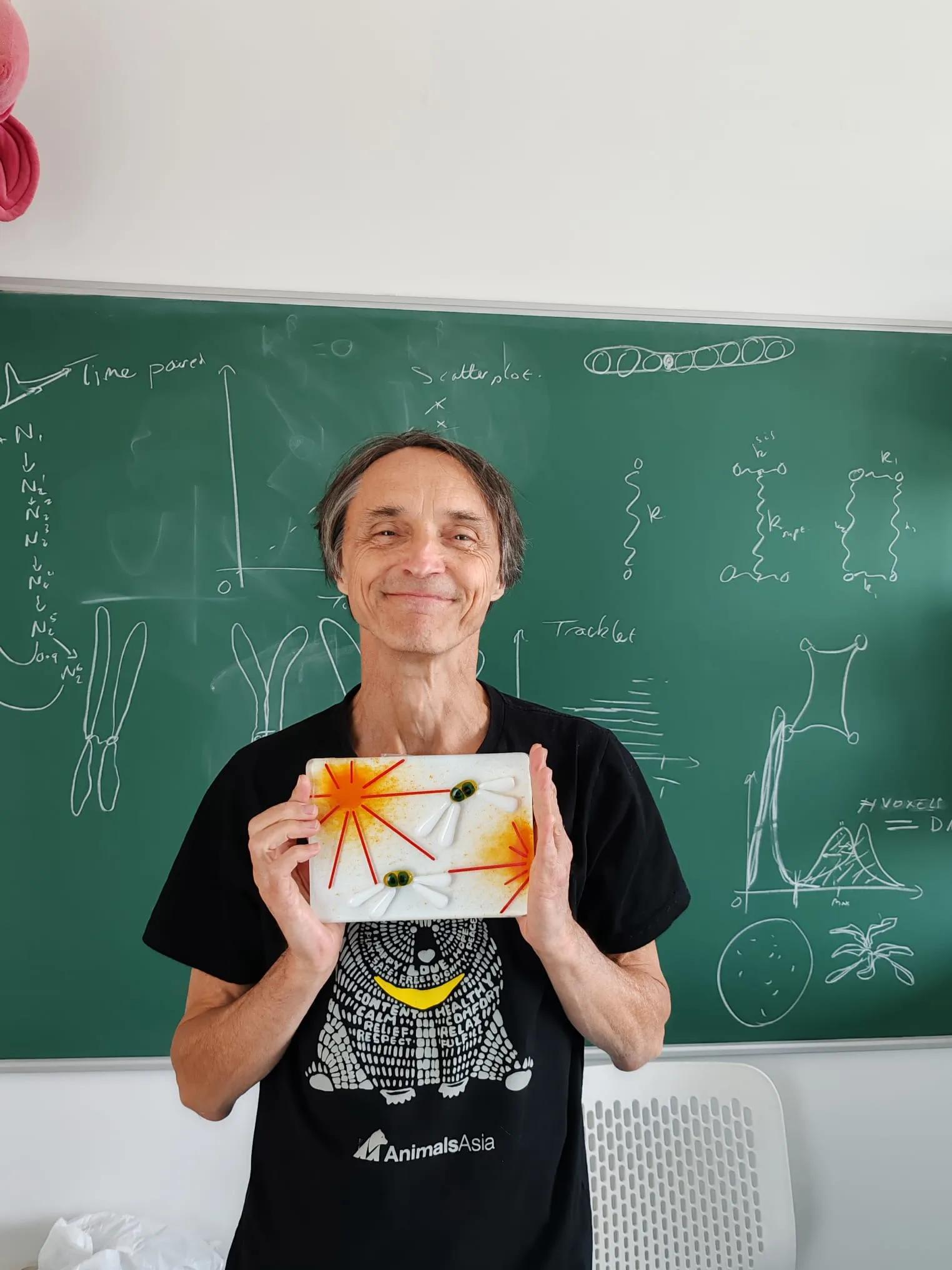 Nigel Burroughs holding his tile artwork "Crafting the metaphase plate".
