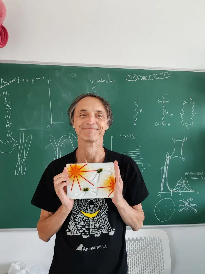 Nigel Burroughs holding his tile artwork "Crafting the metaphase plate".