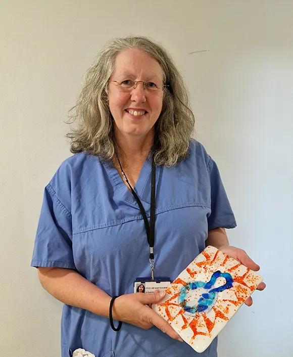 Geraldine Hartshorne with her tile Breaking free.