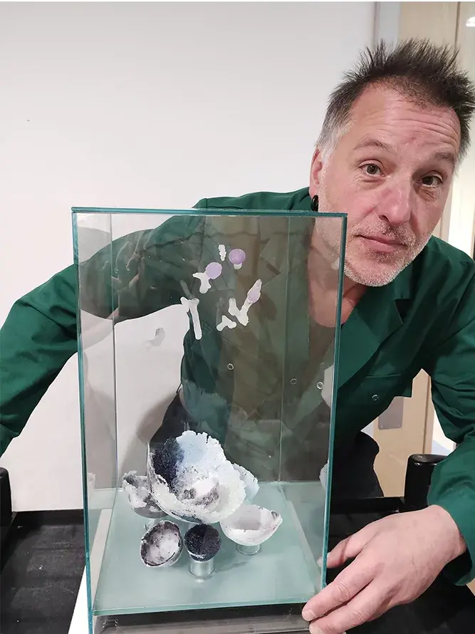 David Mola posing with his artwork The Inner Forest.