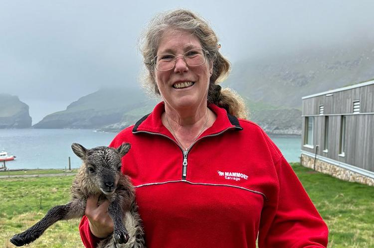 Jill Pilkington holding a lamb.