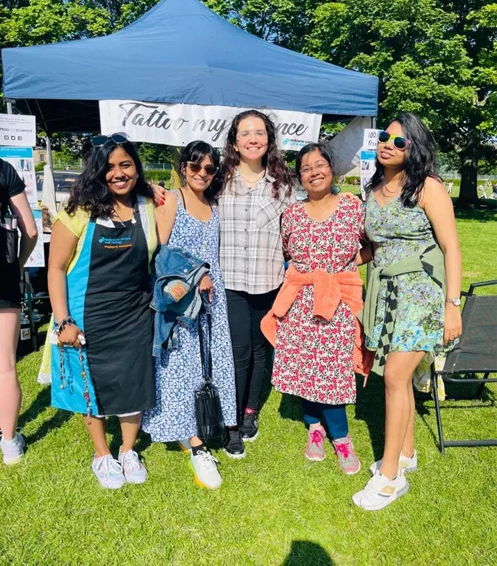 Lab group members stand for a group photo in front of a gazaebo at the science festival