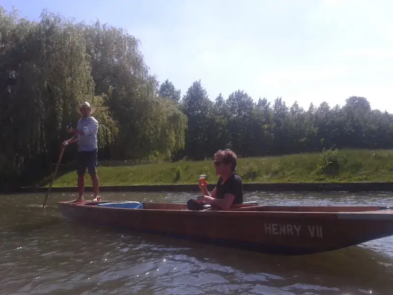 Photo of 2 lab members on a punt, one at down the other using an oar