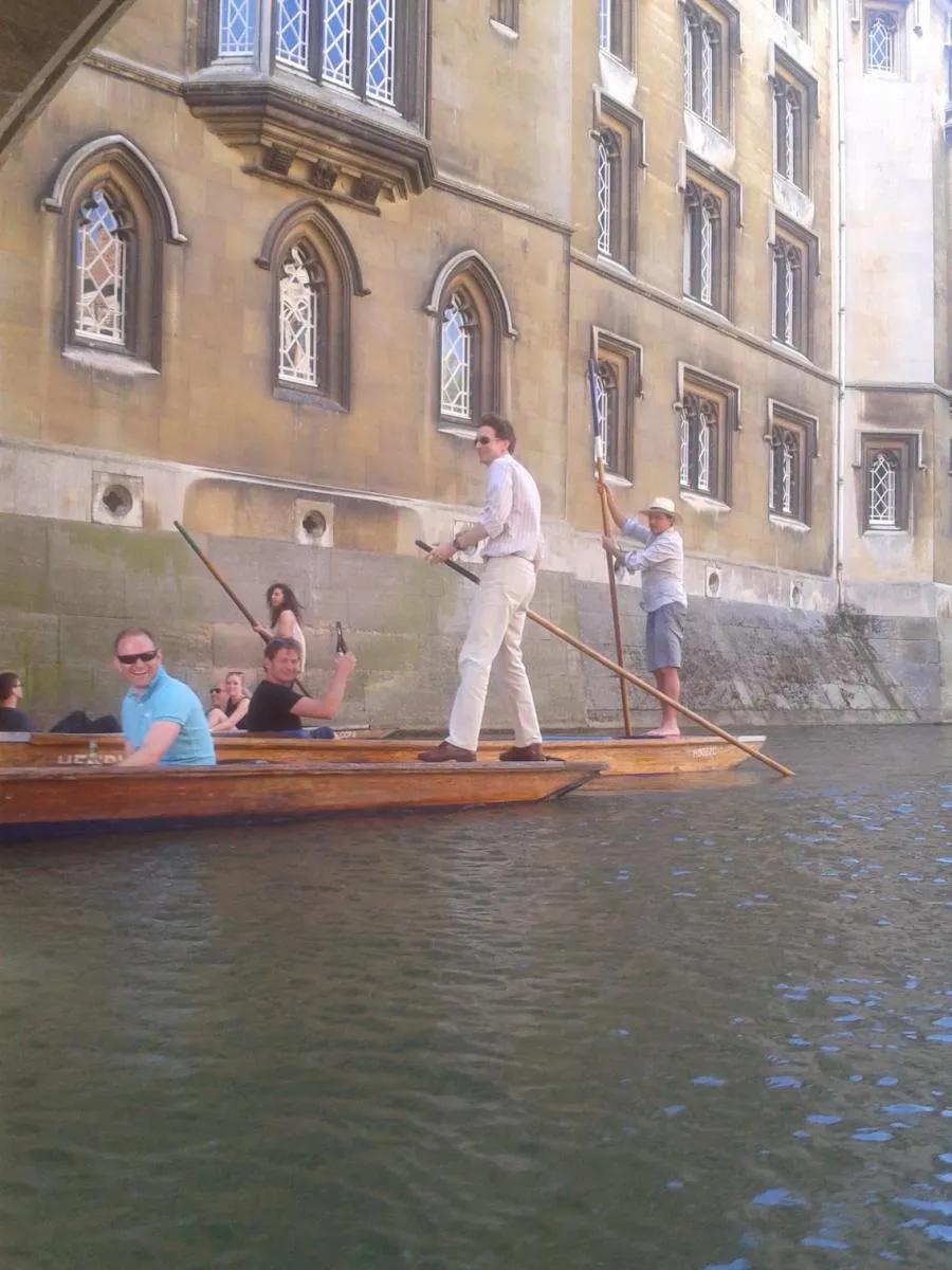 Photo of lab group members on a punt in front of a historic building