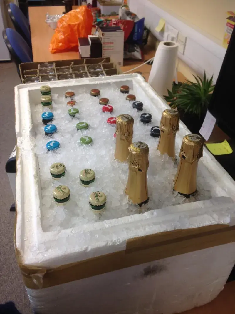 Photo of a polystyrene box filled with ice and bottles on a countertop