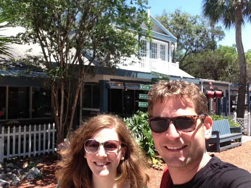 Gerben and a lab group member both wearing sunglasses outside a building surrounded by trees
