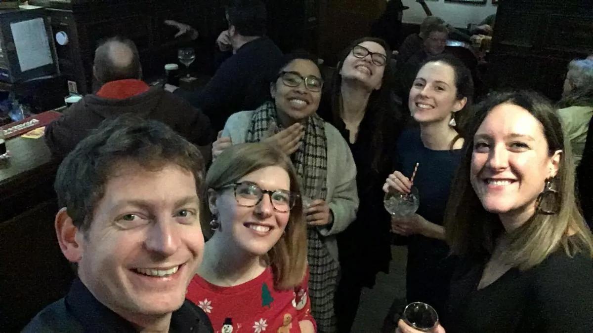 Photo of the lab group members, with drinks, smiling for the camera