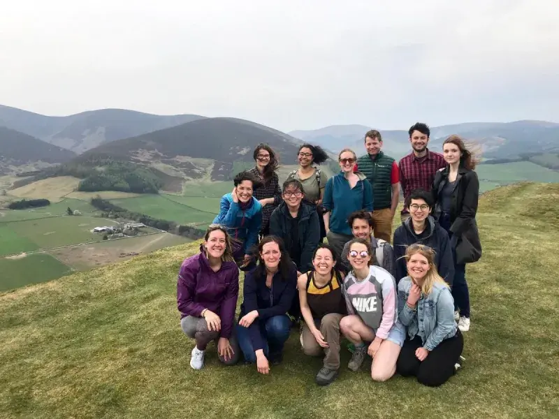 Lab group members pose for a photo at the top of a hill
