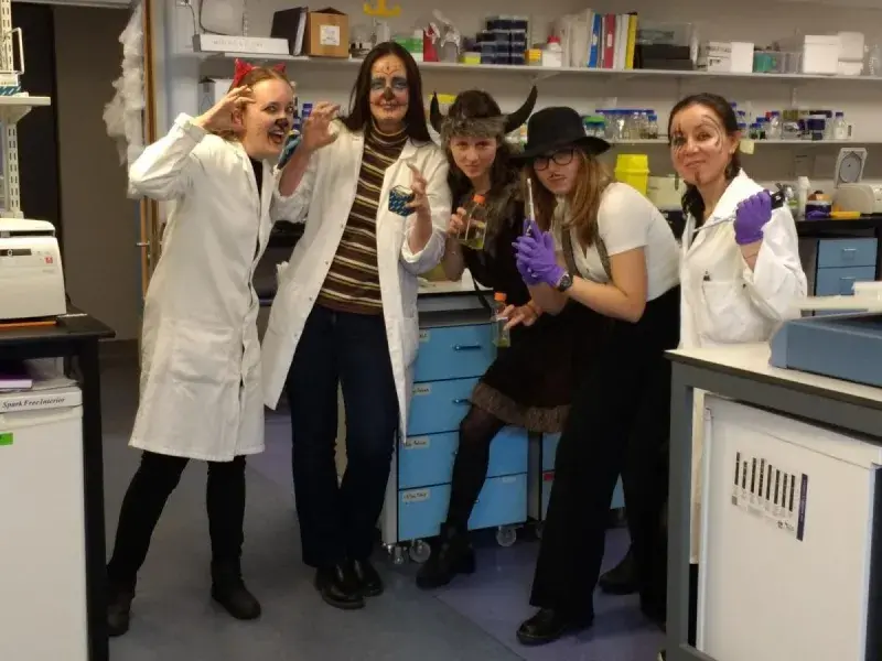 Lab members in the lab with various Halloween costumes