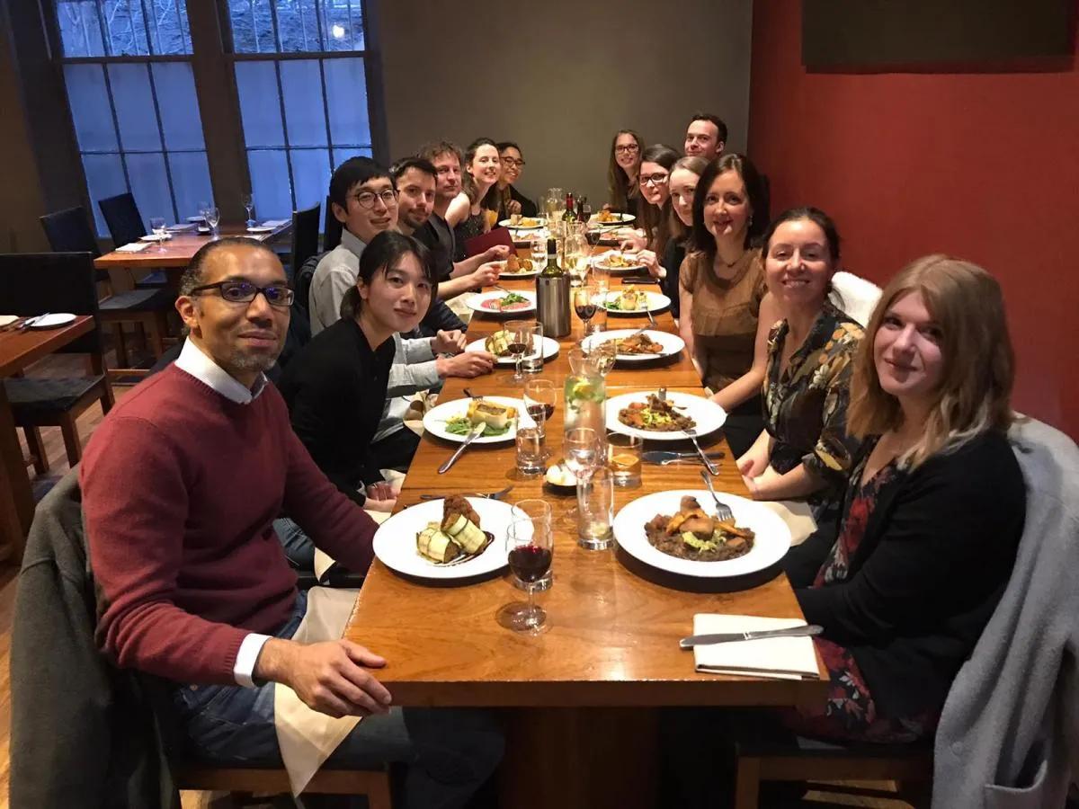 Members of the Spoel and van Ooijen labs sit around a table having Christmas lunch