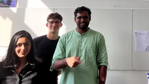 Photo of 3 students posing for a photo at a workshop