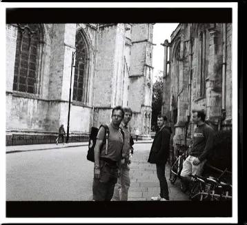 Black and white photo of 3 lab group members outside a partially visible York cathedral 