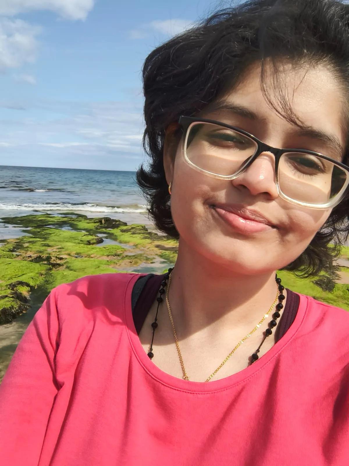 Image of Steffin Rodrigues in front of a sunny coastline