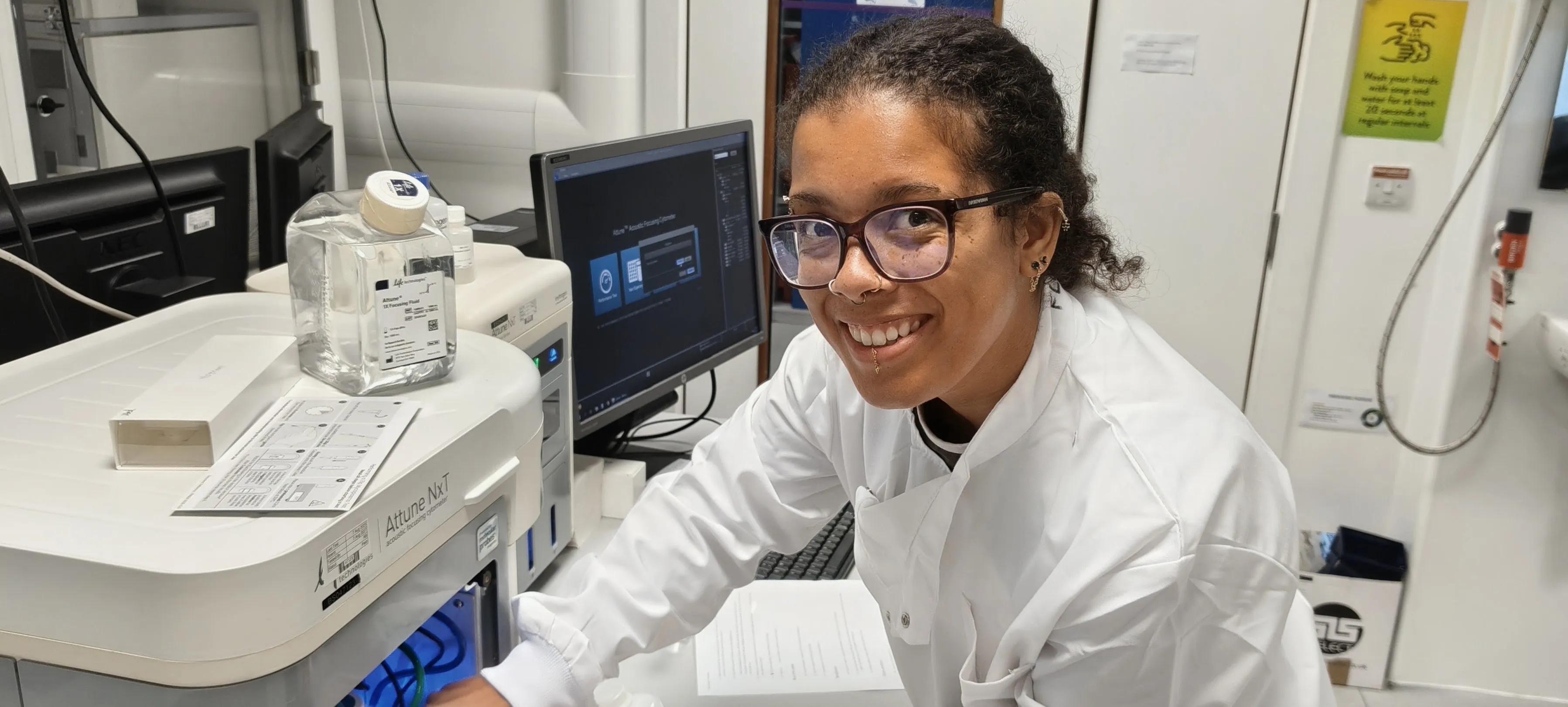 Molly Robertson at an Attune flow cytometer