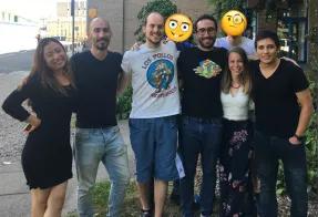 Prof. Chris French and his research group standing together and smiling.