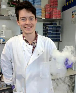 Brendan Largley in the lab, smiling.