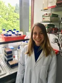 Gediz Kocaoglan in the lab, smiling.