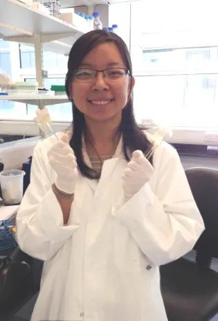 Dr Olivia Wei Liu standing in the lab and smiling.