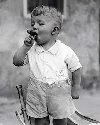 A small child smoking a cigar.