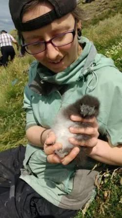 Photo of Katherine Keogan holding a puffin chick