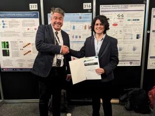Photo of Sofia Esteban-Serna receiving a poster prize at the Microbiology Society conferences in Edinburgh