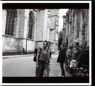 Black and white photo of 3 lab group members outside a partially visible York cathedral 