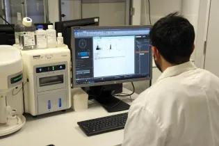 Scientist sitting at an Attune flow cytometer