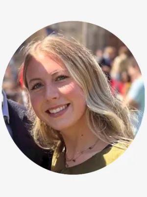 A young woman with blond hair smiling