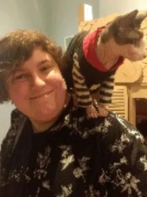 Photo of Ali Hudson with cat on shoulder