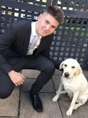 Photo of Michael Jamieson with a golden Labrador dog