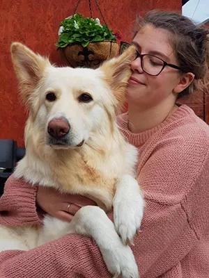 Photo of Olga Zawistowska with a large white dog