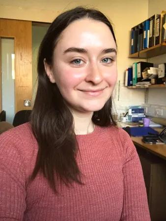 A person smiling in an office
